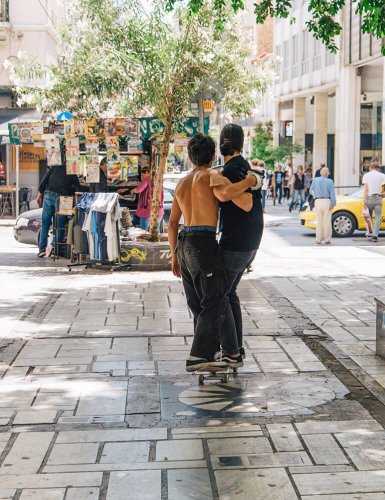 Two skaters on a skateboard on Aiolou Street, Athens