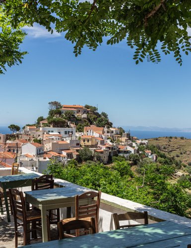 taverna tables with view of town on hill