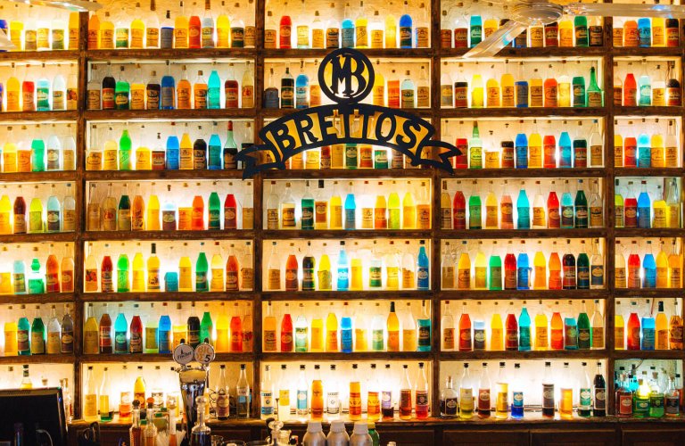 A wall with colourful liquor bottles at Brettos in Athens. 