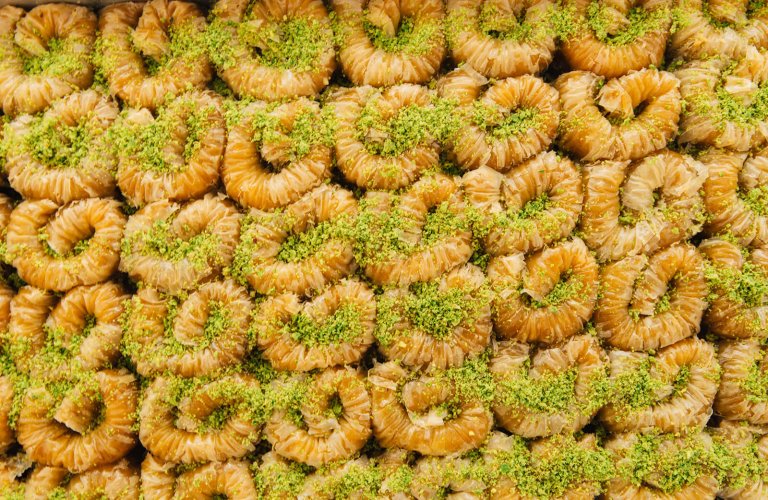 A close up of rows and rows of small baklava.