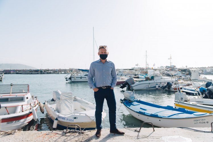 a man wearing a face mask at a port in Athens