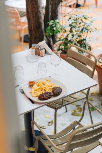 a table set with a dish of patties and fries