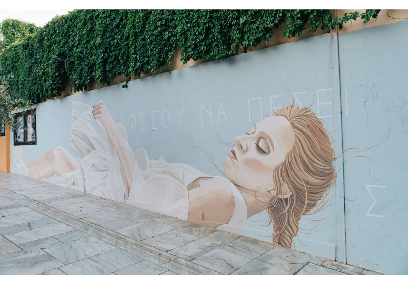 Let Yourself Fall by Duo Amazonas graffiti on the wall of Thiseion cinema in Athens. 