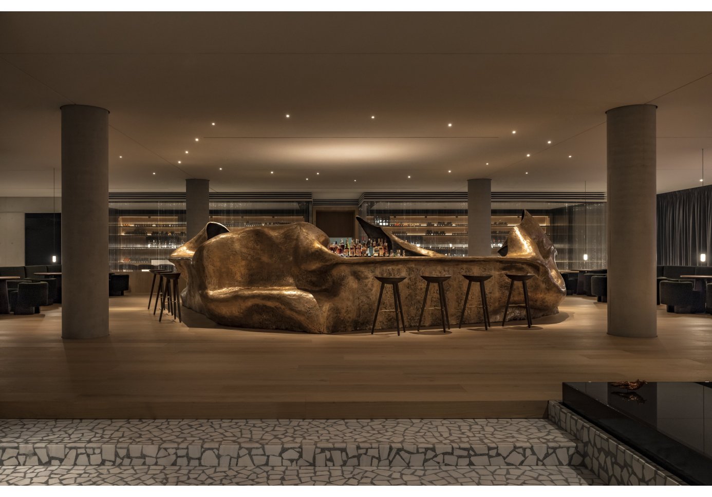 the bar of a michelin-starred restaurant similar to a rock-formation, beige colours, four pillars, 