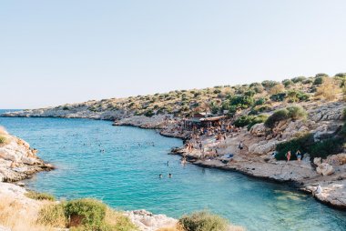 COOL REFRESHMENT - South of the long beaches at Little and Big Kavouri, the fingers of the Athens Riviera create dozens of small coves where Athenians take a dip and chill during the summer.