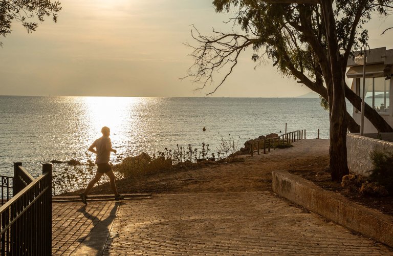 Jogger on Kavouri seaside path, Athens Riviera