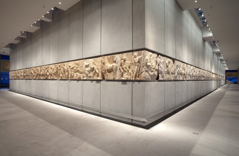 Southwest corner of the frieze, from which began the two streams of the Panathenaic procession. | Courtesy: The Acropolis Museum. Photo by Nikos Daniilidis.