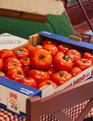 A box of red tomatoes on a table