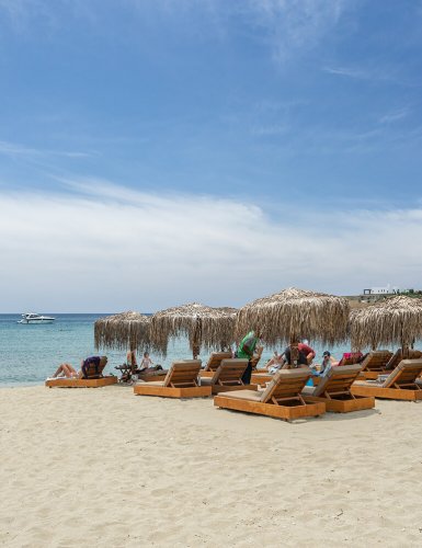 white beach with sunbeds and umbrellas