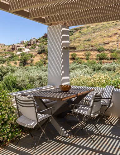 chairs and tables on patio in countryside