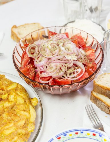 tomatoes and onion and bread in a bowl.