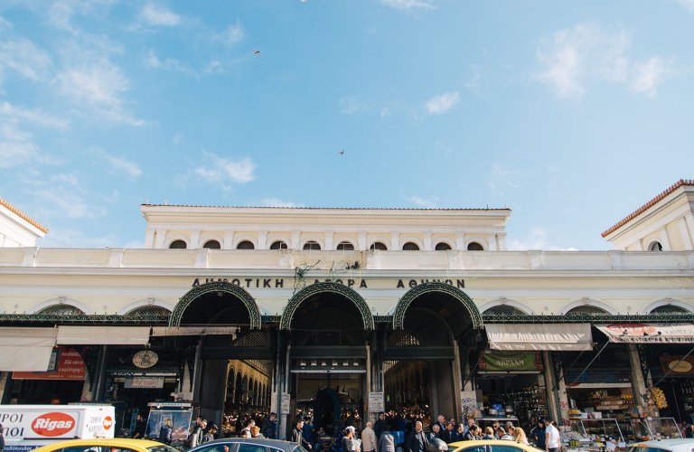 the facade of a building with an entrance to a food market arcade