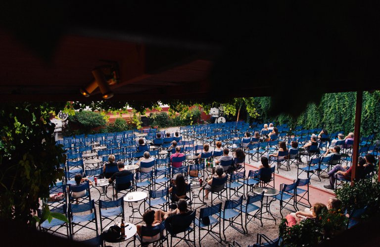 people watching a movie at an open-air cinema