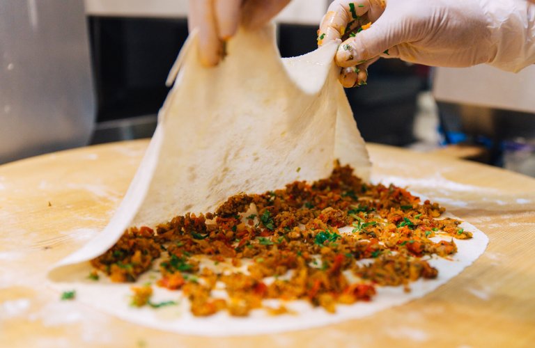 A pie being filled before cooking at Cocona in Athens. 