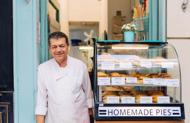 A man standing outside Harry's homemade pies in Athens. 