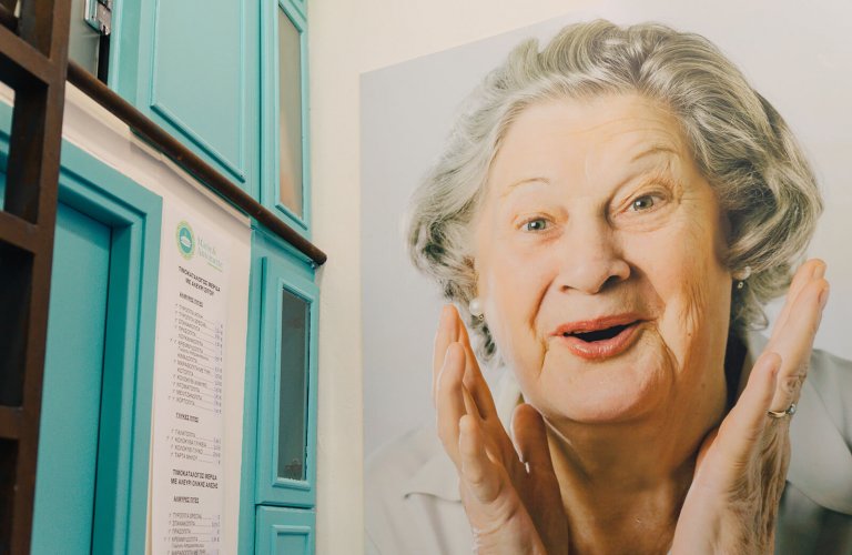 A photo of a woman's face and hands at Marie & Antoinette pie shop in Athens. 