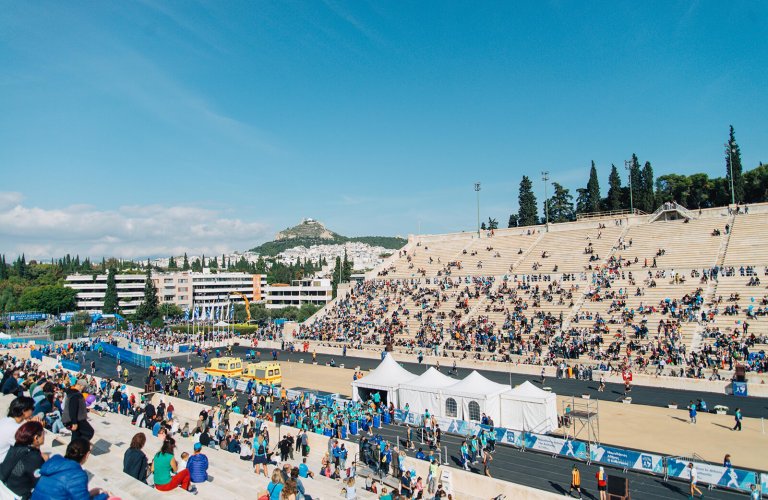 The Panathinaic stadium during the Athens Authentic Marathon full of people.