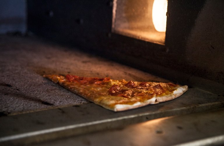 A slice of pizza in the oven at Nonna Edda in Athens. 