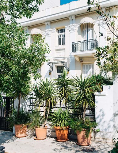 a white house with trees and plants at Palio Faliro in Athens