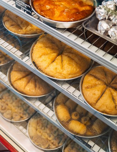 Round pans of desserts at a bakery in Athens. 