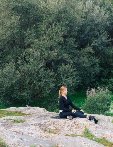 a woman sitting on a rock in Pnyx Athens