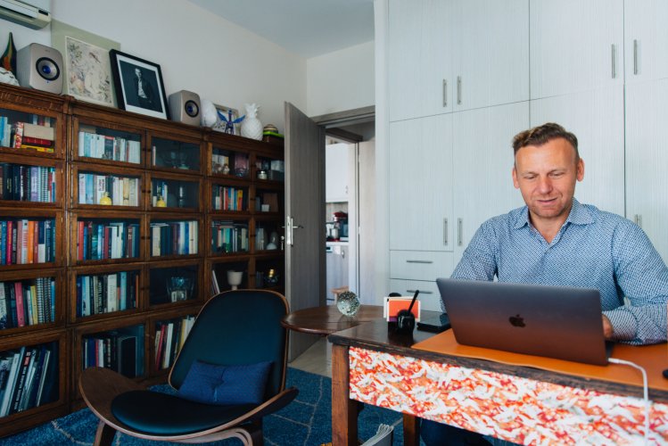 a man working on his desk at his home office in Athens