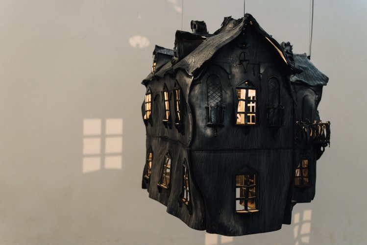 a burnt small scale model of a house at ENIA Gallery in Piraeus