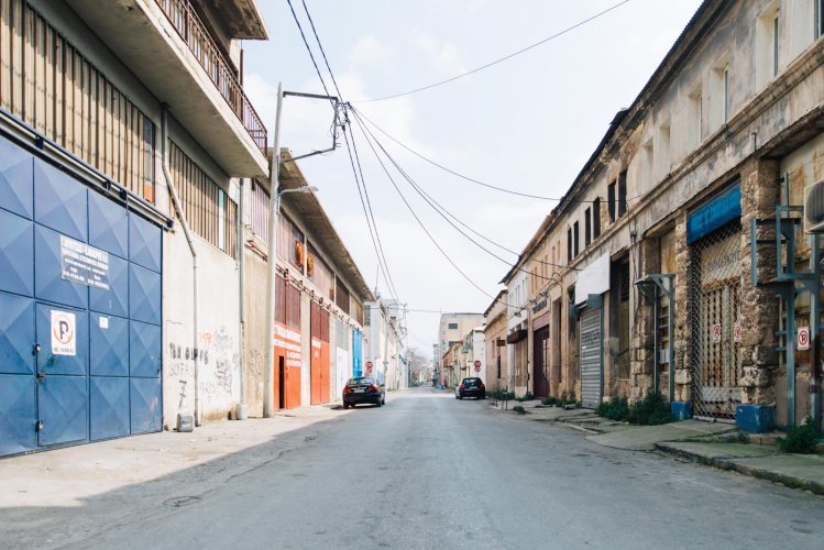 a road with industrial buildings and warehouses in Piraeus