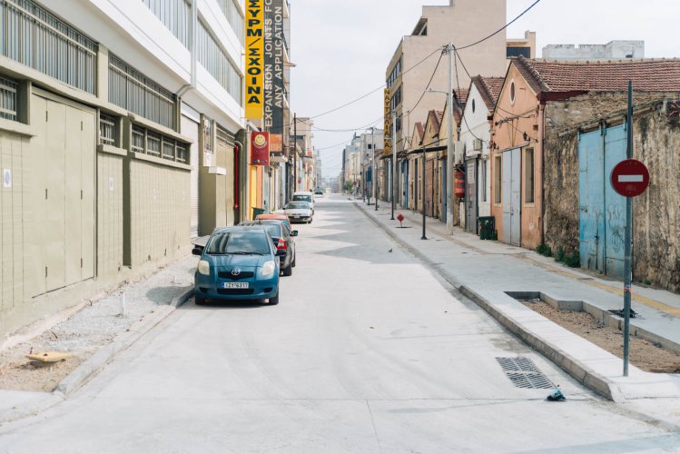 a road with industrial buildings and warehouses in Piraeus