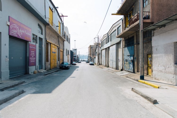 a road with industrial buildings and warehouses in Piraeus