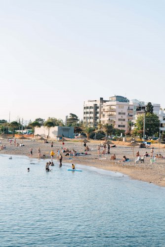 people swimming and sunbathing, urban background.