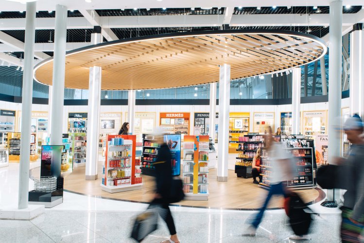 people walking by the duty free space.