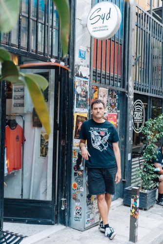 a man standing in front a retail store