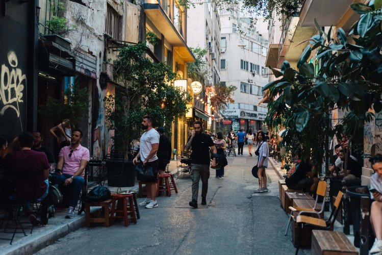 people sitting outside of coffe shops and bars  at Protogenous,