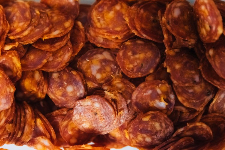 lots or small round pieces of pepperoni.