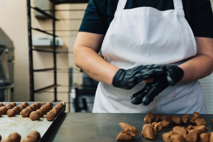 a pastry chef making chocolate bites.