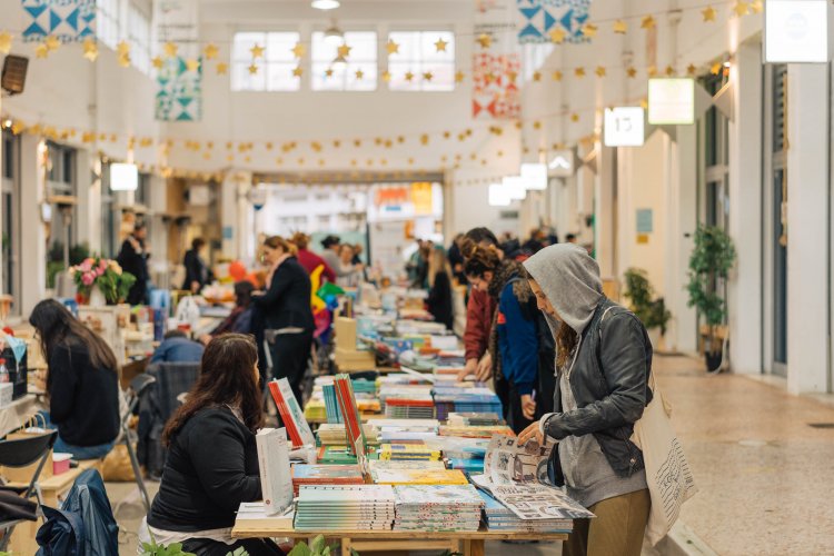 people shopping for books and magazines at an indoor flea market