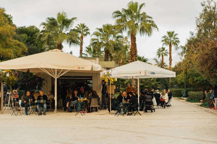 people sitting around the canteen at the park. 