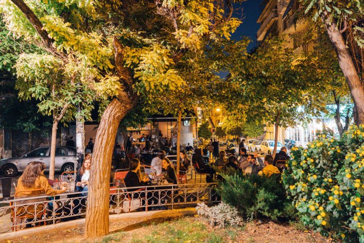 people sitting outdoors at coffee shops, nigh time