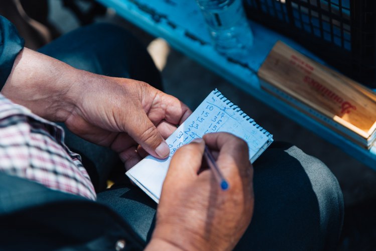 a man writting down the score of a game.