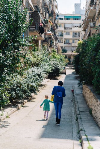 a woman and a child walking on the street. 