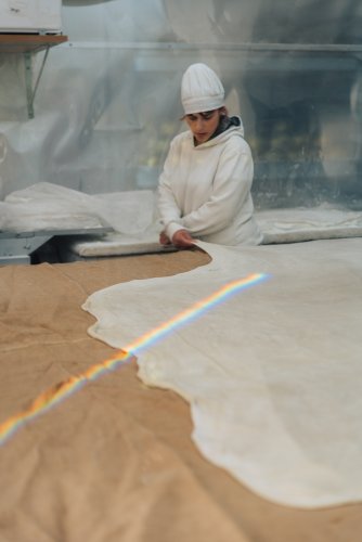 a woman stretching the dough.
