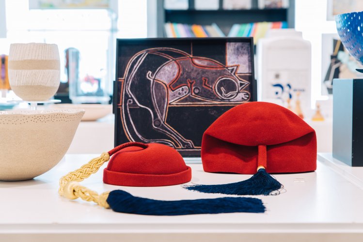 Red hats with blue edges on display.