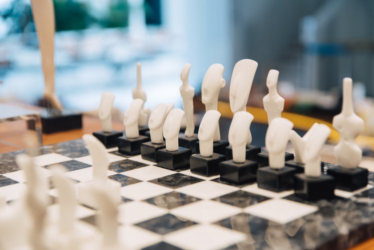 a chess set with cycladic figurines as chess pieces.