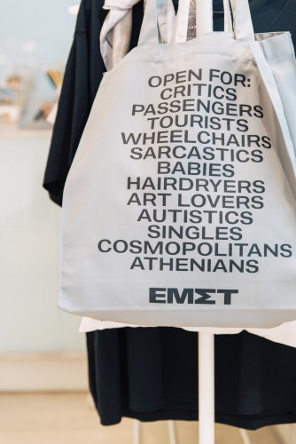 a white tote bag with black lettering.