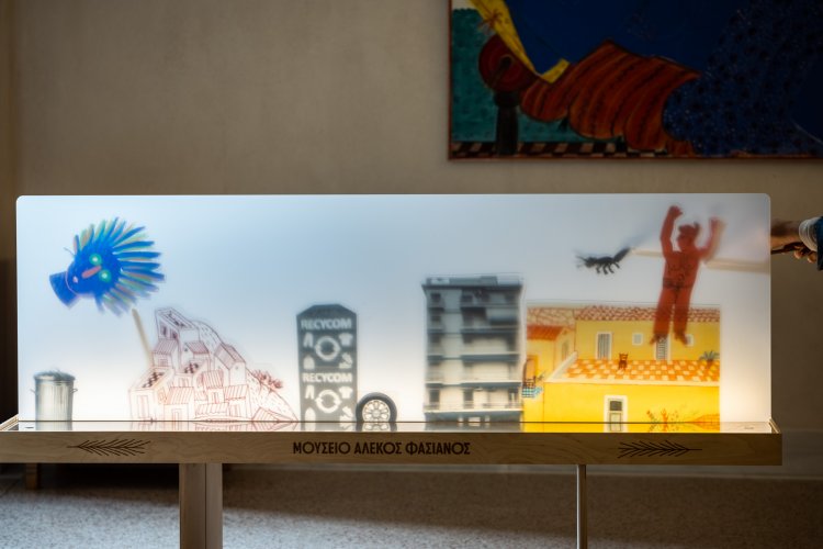 a lit art installation on a stand with the sign Alekos Fassianos Museum.