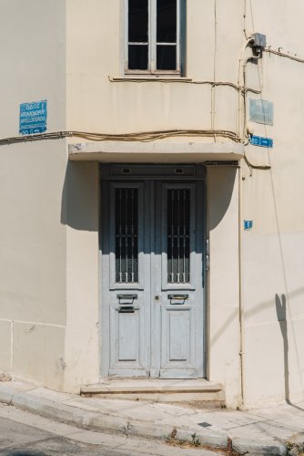 a blue door of a two storey house.