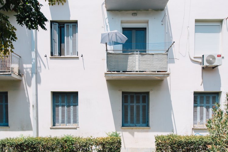 a block of flats with blue windows.