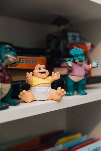 Vintage toy figures on a shelf.