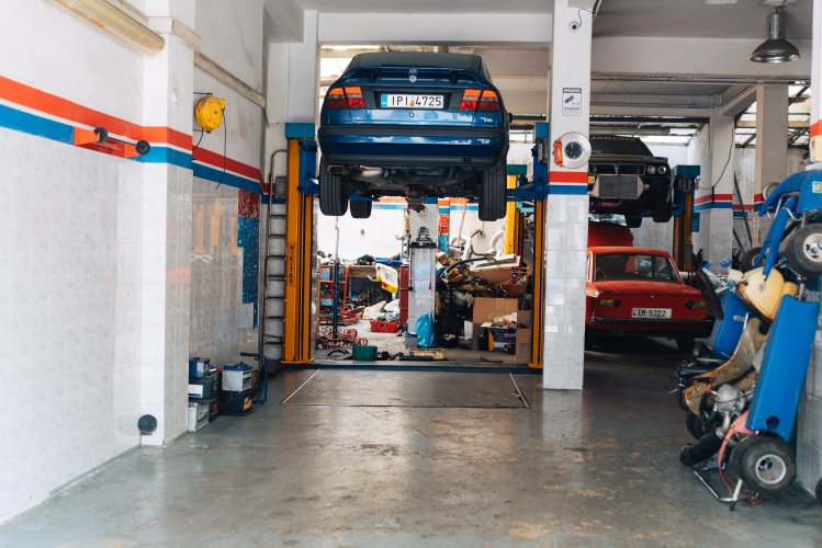 a car lifted in a car shop.